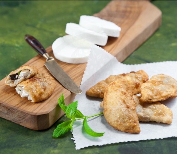 Fried pies stuffed with aubergines frumenty manouri cheese and mint