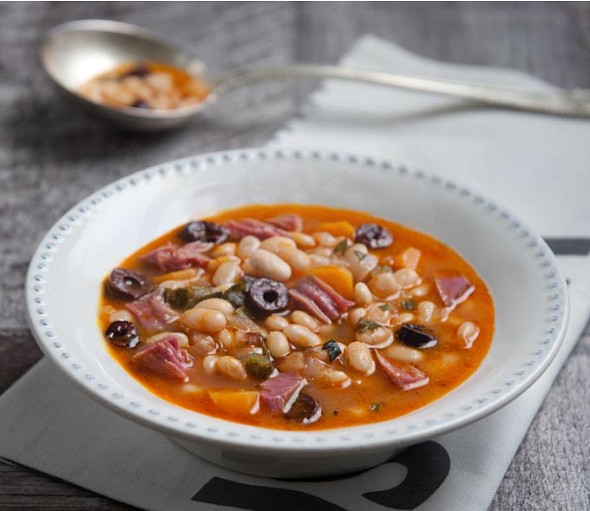 Bean soup with smoked pork, olives and orange