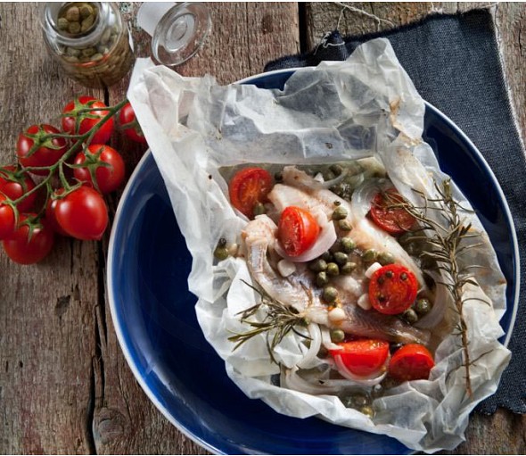 Fish baked in baking paper with rosemary and green pepper